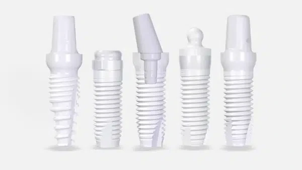 Ceramic dental implant shown beside a natural tooth
